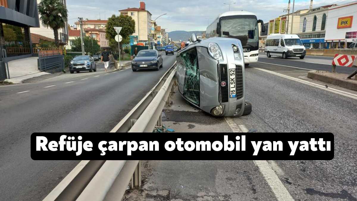 Kocaeli'nin Körfez ilçesinde refüje çarpıp yan yatan otomobilin, yan yola