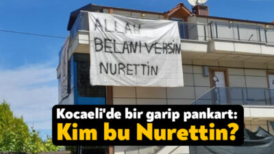 Başiskele'deki bir binaya asılan "Allah belanı versin Nurettin" yazılı pankartla