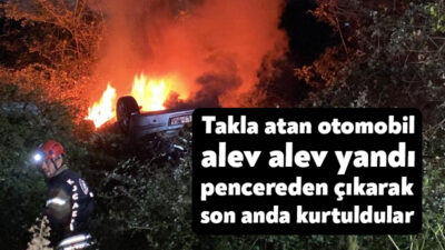 Kocaeli'nin Kartepe ilçesinde takla atarak ağaçlık alana uçan otomobil alev