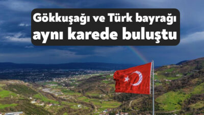 Kocaeli'de gökyüzünde beliren gökkuşağı ile kentin yüksek kesimlerindeki Türk bayrağı